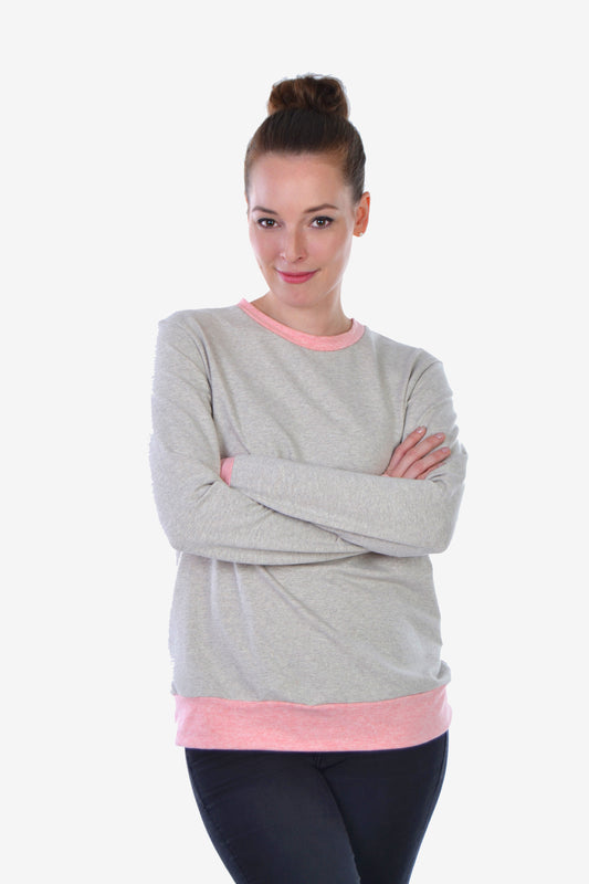 Model trägt einen Pullover aus Baumwolle in beige mit rosa Kragen und Saum von LA.LUKA Berlin